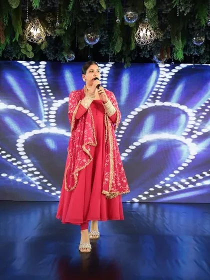 Commanding the stage during a Sangeet Sandhya. A powerful stage presence is key to keeping hundreds of guests engaged and entertained throughout the evening.
