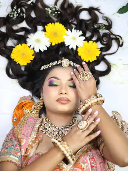 An ethereal overhead shot of a model with flowers in her hair. This type of creative shot is perfect for a portfolio, showcasing skills in both hair and makeup.