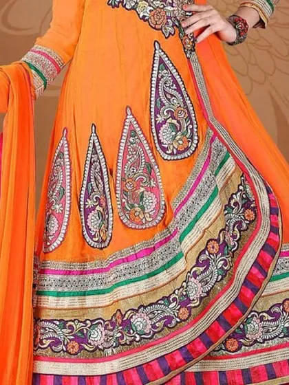 A bright orange Anarkali suit with intricate paisley embroidery. This style is perfect for functions where you want a grand and elegant look.