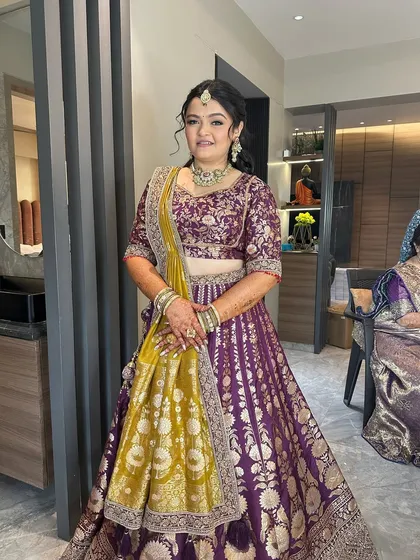 A full view of the bride's outfit, showing how the elegant half-up hairstyle and draping come together.