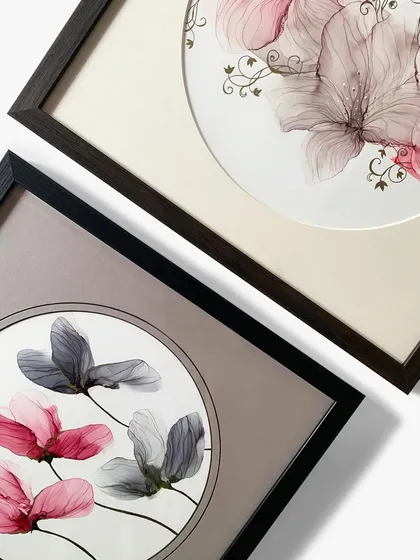 A pair of the floral artworks with round mats, showing how they can be displayed together as a beautiful, coordinated set.