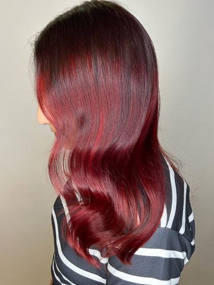 A side view of the Merlot Hair color. You can see the subtle face-framing highlights and the way the deep red and plum tones blend together seamlessly for a luxurious finish.