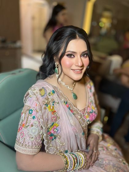 A beautiful engagement bride in a lovely floral lehenga. The makeup has soft pink tones to match the embroidery on her outfit.