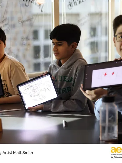 Students proudly display the characters they've designed on their tablets. Our visiting artist program integrates technology with traditional art forms, teaching modern creative skills.