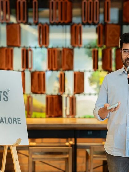 A smiling performer at our "Seasons" meetup. The event felt like a warm hug, with poems that bloomed, rained, and danced.