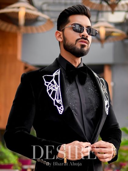 This shot captures the modern elegance of the black velvet blazer, a perfect piece for any man who values luxury and detail.