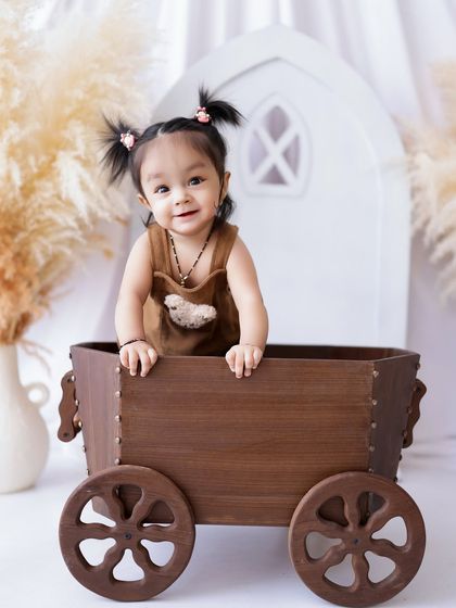 This little girl's happy expression is infectious. The simple, bright background keeps the focus entirely on her.