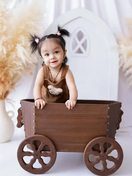 This little girl's happy expression is infectious. The simple, bright background keeps the focus entirely on her.