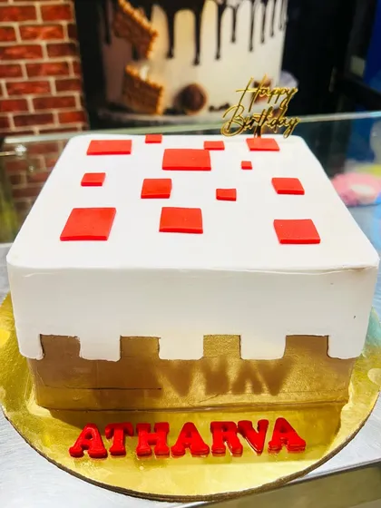 A minimalist yet instantly recognizable Minecraft cake block. This square cake is designed to look like a piece of the game's terrain, making it a cool and modern choice for a fan's birthday.