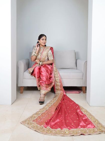 A side view of the pink Nauvari, showing the beautiful drape and long trail.