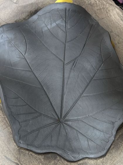 This is the leaf platter in its 'greenware' stage, before it was fired. You can clearly see the delicate impression of the real leaf I used to create the texture, capturing its natural beauty in raw clay.