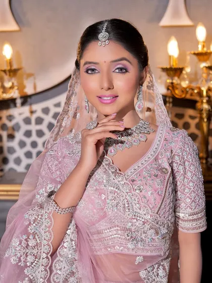 A captivating portrait of the bride. Her eyes are the focal point, with a beautiful blend of purple and pink shadows that make them pop. The rest of the makeup is kept soft and glowing.