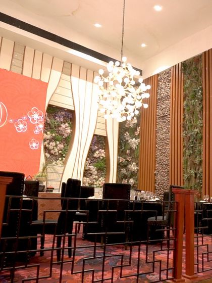 The "Naoki" Pan-Asian dining setup, where modern design elements like vertical gardens and contemporary lighting create a chic and immersive restaurant experience.