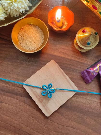 A lovely blue floral rakhi made with thread. This design is simple, elegant, and celebrates the spirit of Raksha Bandhan.