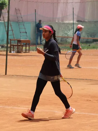 A young player with intense focus during a tournament match. We train our players to maintain their concentration from the first point to the last.