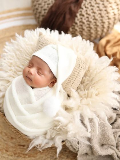 A peaceful newborn surrounded by soft, earthy tones. This boho-inspired setup is perfect for a natural and timeless look.