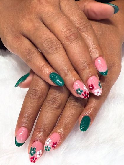 A cheerful, garden-inspired design. This set combines a classic green French tip with accent nails featuring hand-painted red and white flowers on a sheer pink base.