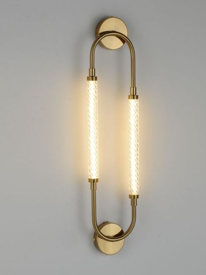 A modern wall sconce with two textured acrylic tubes in a U-shaped brass frame. A variation of our popular design, perfect for bathrooms or hallways.