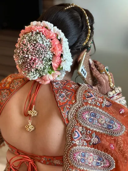 A side view of the stunning ombre floral bun, a modern twist on a classic bridal hairstyle.