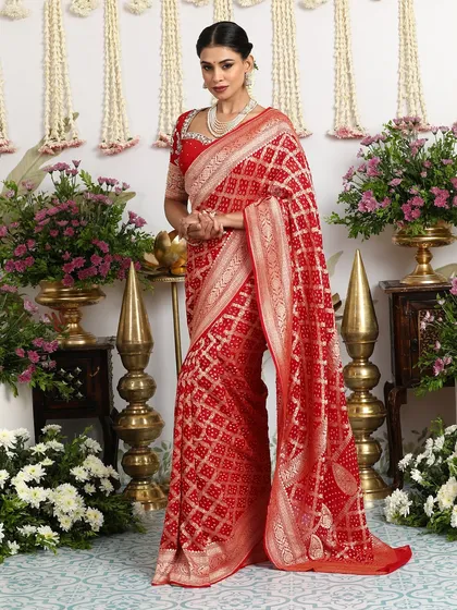 The full view of the red Banarasi Bandhani saree, a timeless and elegant choice for a bride or wedding guest.