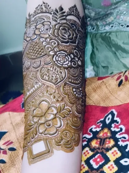 A series of shots showcasing the bridal mehndi for Tabassum. The design features bold, prominent roses that wrap around the arm.