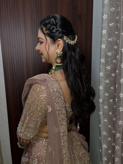 A side profile showing off the intricate braided hairstyle and how it completes the entire engagement look. The hair accessory adds a perfect touch of elegance.