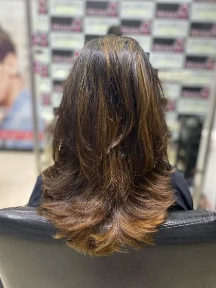 Another view of this beautiful layered cut with highlights, showing how the color and cut work together to create a full, dimensional style.