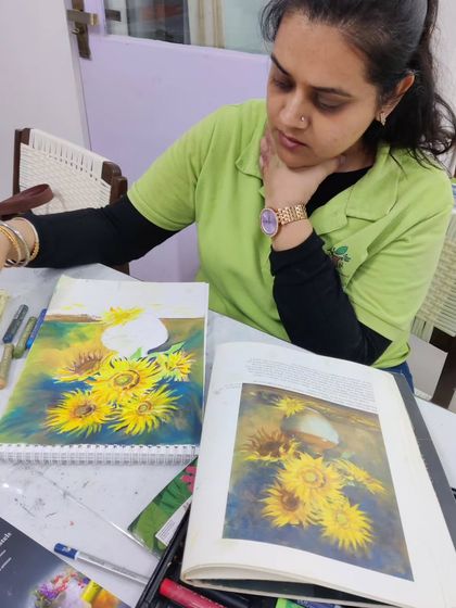 An adult student uses oil pastels to recreate a famous sunflower painting, learning blending techniques for this rich medium.