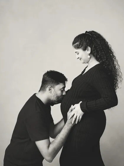 Sometimes, the most powerful images are the simplest. This black and white portrait focuses on the quiet, intimate connection between a father and his unborn child, a moment of pure anticipation and love.