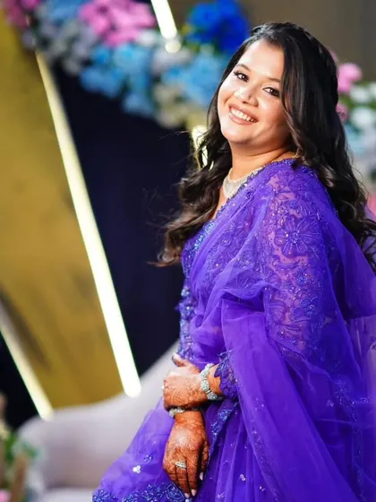 The full look in all its glory. The purple saree and soft makeup create a beautiful and elegant combination.