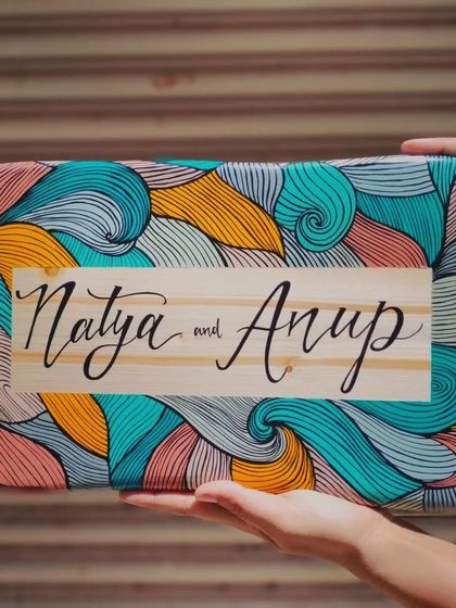 A duplicate of 167, we love how this boho-inspired name plaque for "Natya and Anup" turned out. The natural wood grain contrasts beautifully with the colorful, intricate line art.