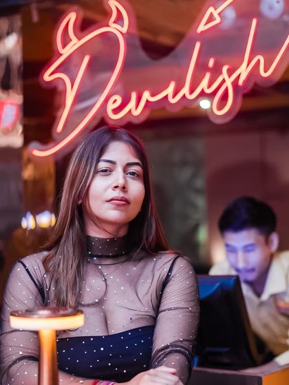 The neon 'Devilish' sign adds to the cool, edgy decor of the venue.