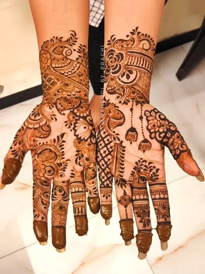 A beautiful blend of Indian and Western styles. This design combines traditional elements like a peacock and hanging 'jhumkas' with modern geometric patterns and spacing.