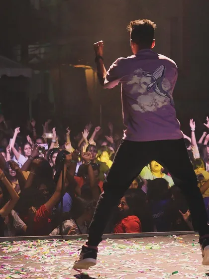 This is my playground. Jumping on stage, feeling the energy from the students at Mount Carmel College. College fests are my specialty, and I make sure they are unforgettable.