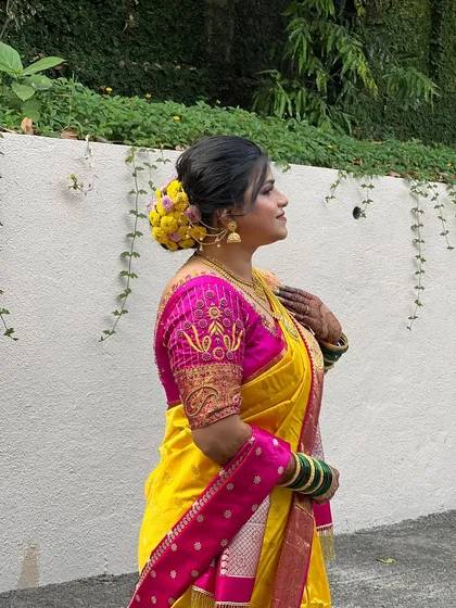 A side profile of my bride Krutika, showing off her beautiful floral bun made with yellow flowers.