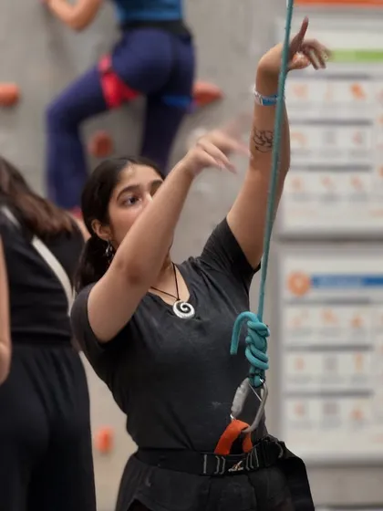 A belayer manages the rope for her partner. Climbing is built on trust and partnership, and our community embodies that spirit.