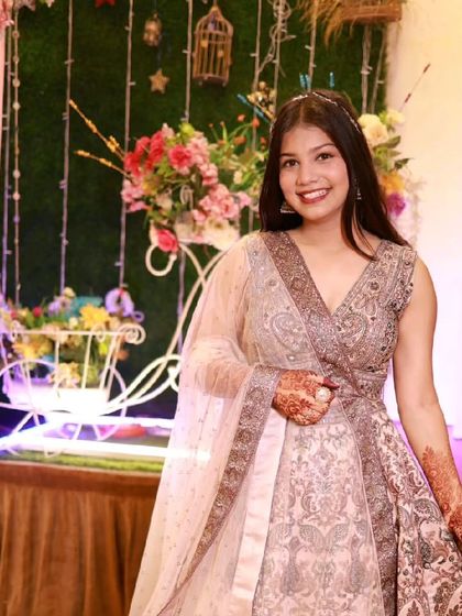 Our client looks so happy and beautiful in this elegant embroidered lehenga. It's a versatile piece that works for many different wedding events.