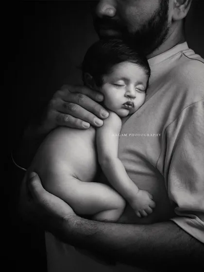 These precious moments. A father holds his sleeping baby close to his chest. The black and white edit makes this an incredibly tender and timeless portrait.