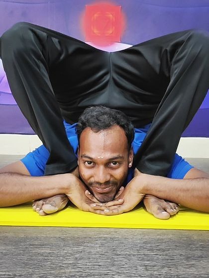 This yogi shows incredible flexibility in Supta Kurmasana (Sleeping Tortoise Pose), a deep forward bend that calms the nervous system.