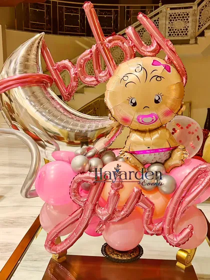A cute 'Baby Girl' foil balloon bouquet. This can be used as a centerpiece or a standalone decoration to announce the happy news.