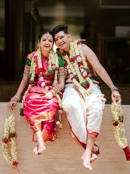 A joyful portrait of the couple on the oonjal, their laughter and happiness are palpable.