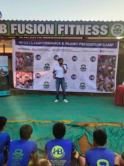 An expert addresses young athletes at our Sports Performance & Injury Prevention Camp. These partnerships provide invaluable knowledge on fitness and safety.