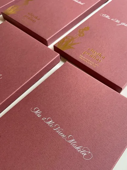My love affair with white ink never ends. Here, I'm doing envelope calligraphy in white on beautiful pink invitation boxes for a client.