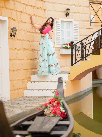 A travel-themed fashion shot, evoking the canals of Venice. The model's pastel gown and the charming European-style setting create a romantic and picturesque scene.