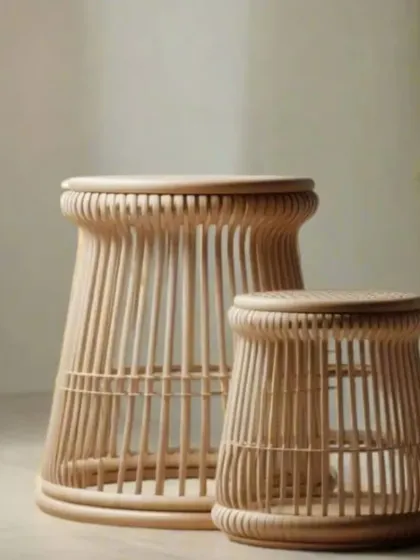 A pair of our nested rattan side tables or stools. The slatted design is both modern and timeless, and their varying sizes allow for versatile use as seating, tables, or plant stands.