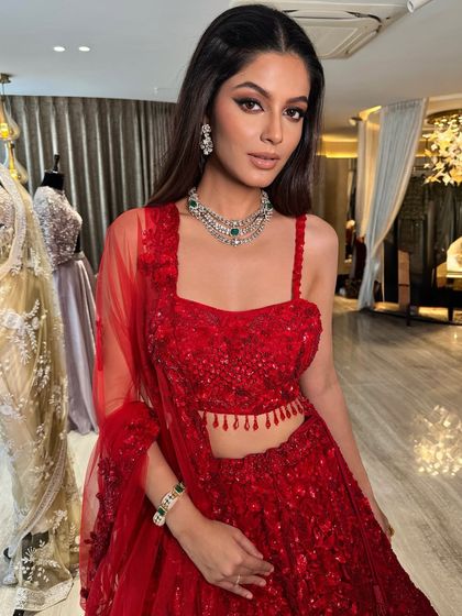 Elevating this stunning red lehenga with my signature perfect winged eyeliner. This look is all about classic glamour with a modern edge.