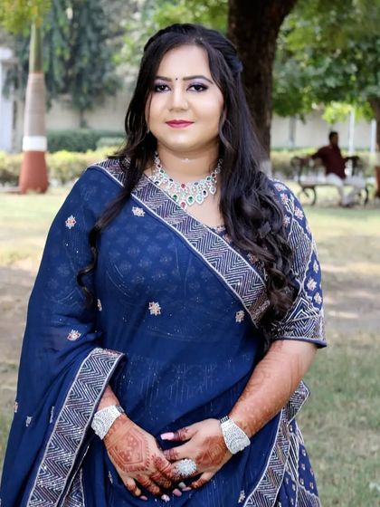A full view of the engagement bride in her beautiful blue bandhani-style lehenga.