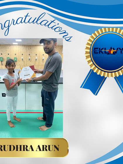 A coach presents Rudhra Arun with her certificate. The supportive relationship between our coaches and students is key to our success.