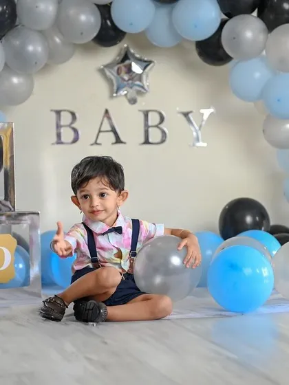 Celebrating the big TWO! This birthday setup features a balloon arch and letter blocks spelling out 'TWO'. It's a fun and festive way to capture your toddler's personality as they celebrate their second birthday.