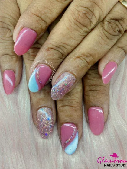 A sweet and girly design with plenty of sparkle. We combined solid pink nails with accent nails featuring a pop of baby blue and a full-coverage, multi-color glitter for a fun and glamorous look.